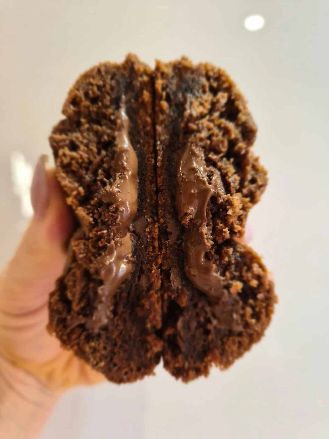 OKJA Chocolate Cookie broken open showing a gooey chocolate centre
